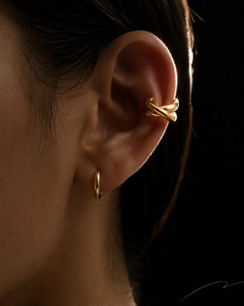 Gold Axis ear cuff worn on the helix with a gold hoop on the lobe, no piercing needed