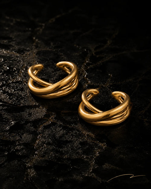 UNCLIPT Axis ear cuff pair in polished gold on wet black stone, no piercing needed