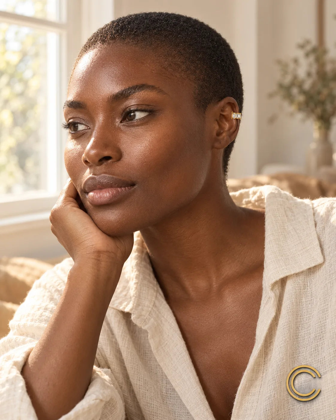 Woman wearing the Gold Baguette ear cuff at home in natural window light