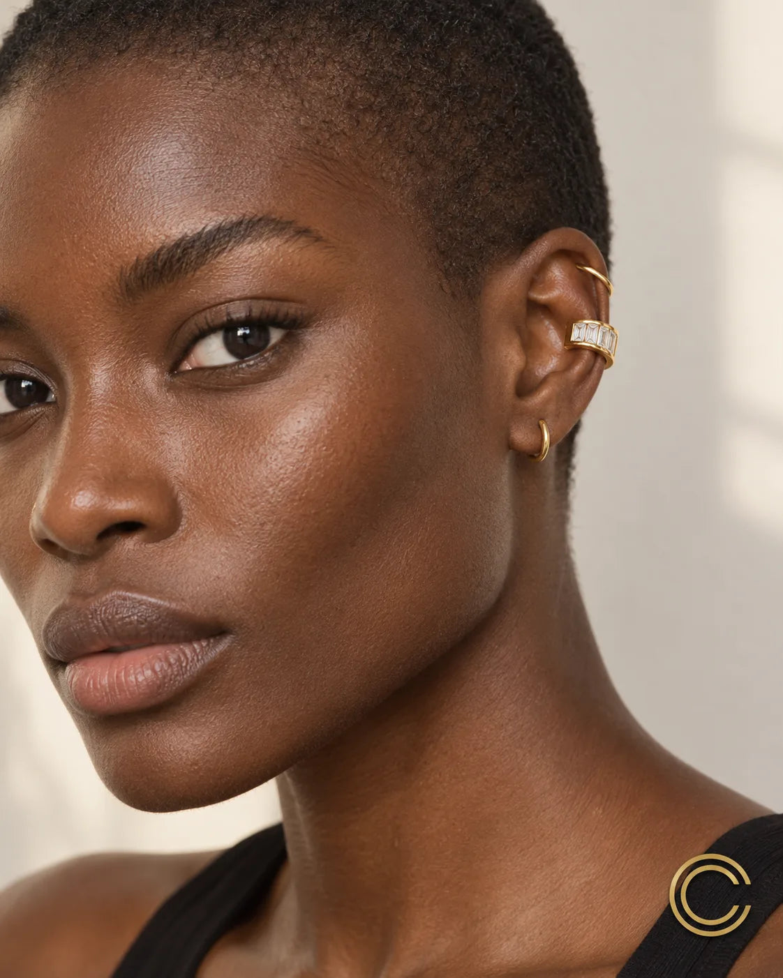 Gold Baguette ear cuff worn high on the upper ear cartilage, stacked with two thin gold pieces, no piercing needed