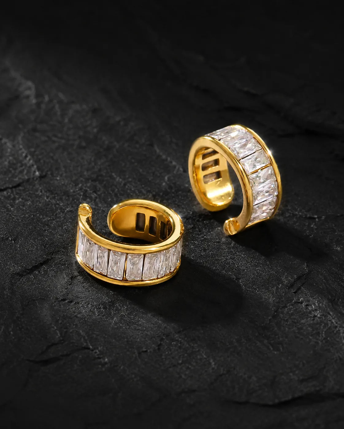 Pair of Gold Baguette ear cuffs with clear baguette zirconia on black slate
