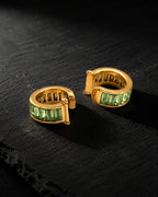 Pair of Jade Baguette ear cuffs with green baguette zirconia on black slate
