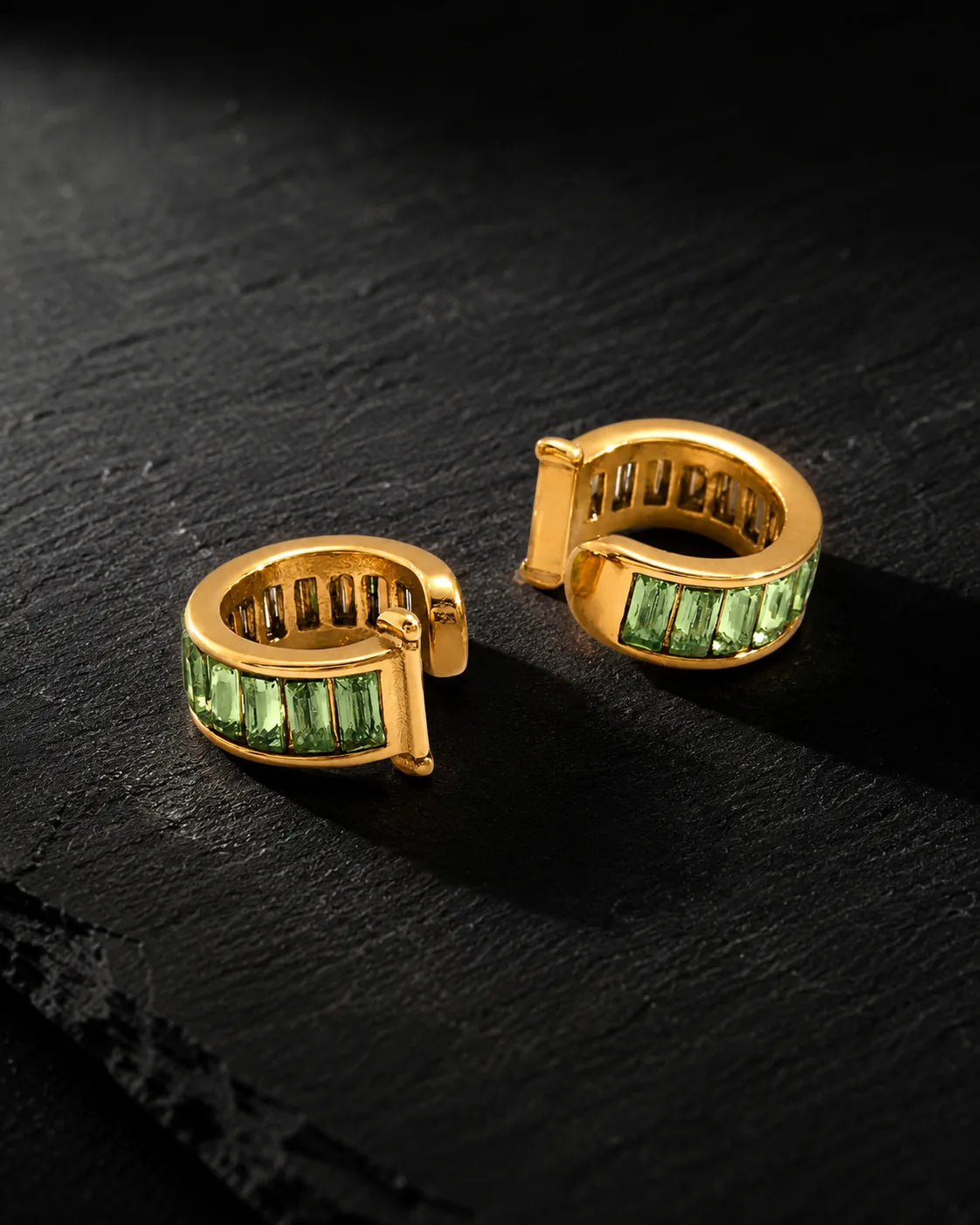 Pair of Jade Baguette ear cuffs with green baguette zirconia on black slate