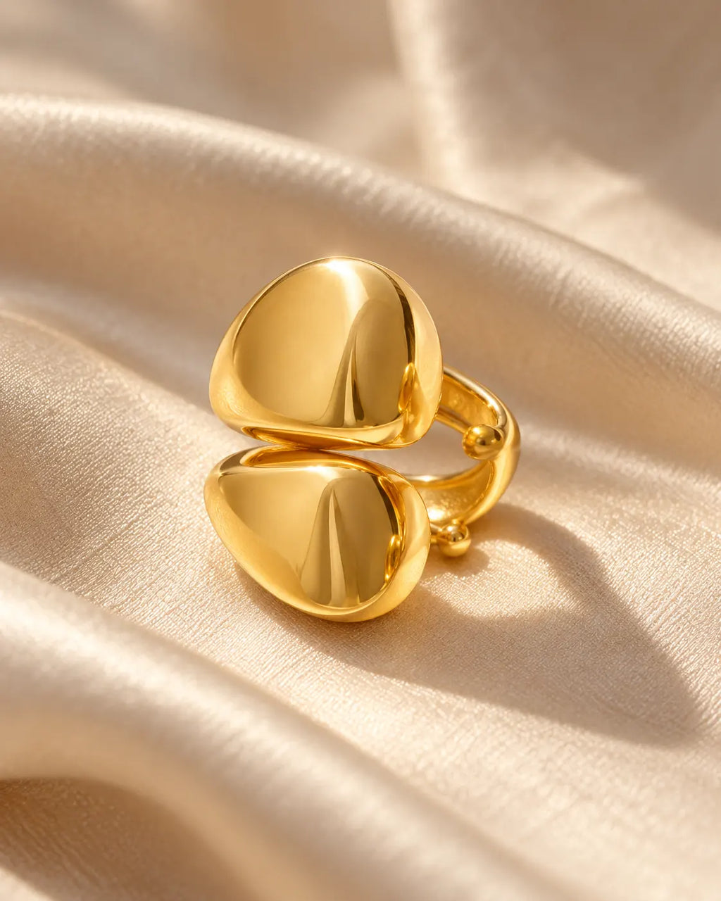 Echo Double Ear Cuff on champagne silk, turned to show the open band that clips onto the ear. No piercing needed.