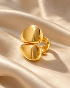 Echo Double Ear Cuff on champagne silk, turned to show the open band that clips onto the ear. No piercing needed.