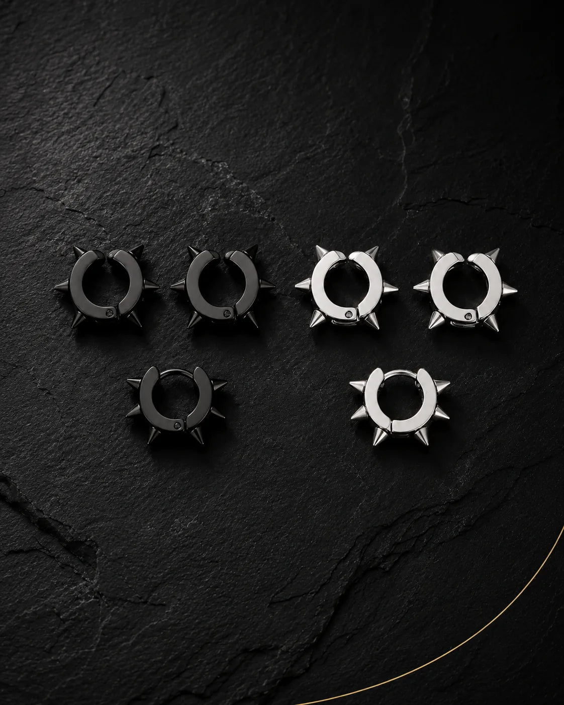 Spike ear cuff set in matte black and silver on black slate, punk style, no piercing needed