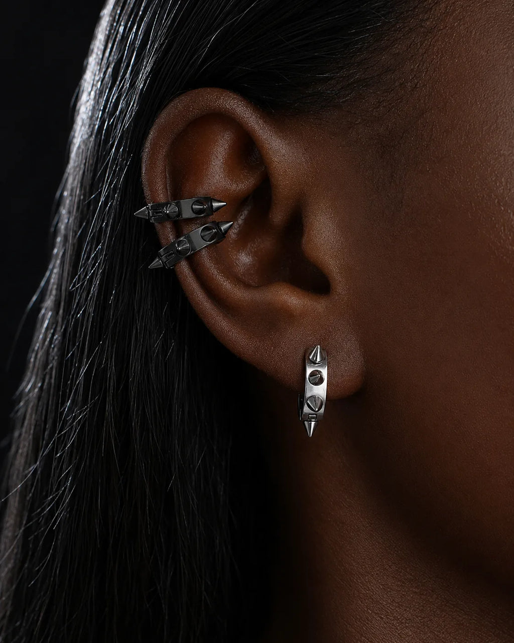 Spike ear cuffs worn on the upper ear with a spike huggie on the lobe piercing