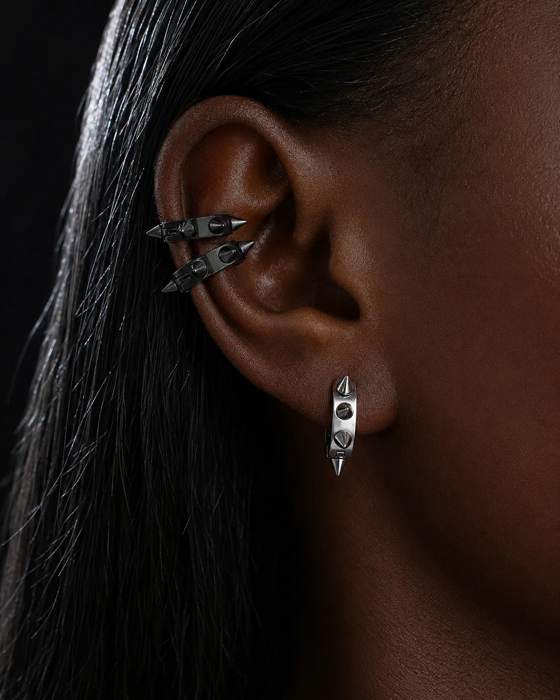 Spike ear cuffs worn on the upper ear with a spike huggie on the lobe piercing
