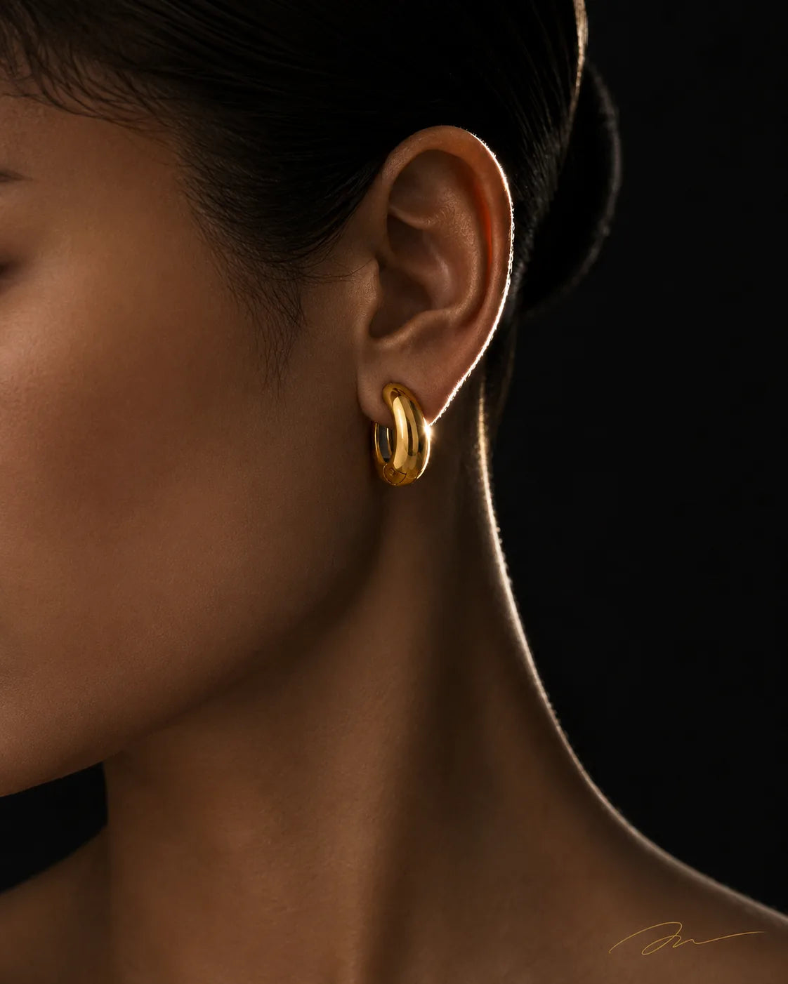 Gold Vault Huggie worn on the lobe, chunky polished gold huggie earring, no piercing needed