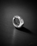 Single silver Vault Huggie on dark brushed surface, polished chunky huggie earring, no piercing